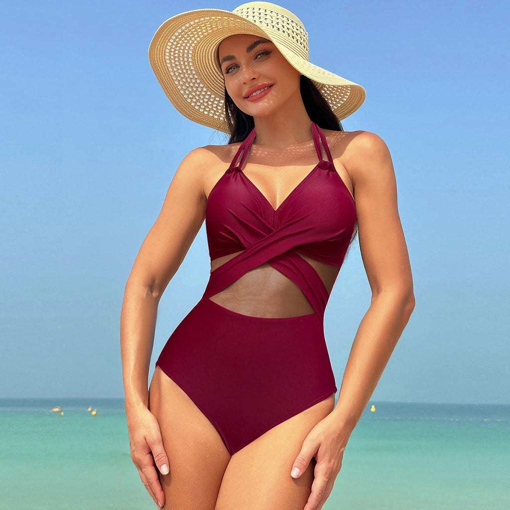 Stylish one-piece swimsuit featuring a flattering halter neckline with cross-straps and beautiful mesh detailing. Perfect for a confident beach look.