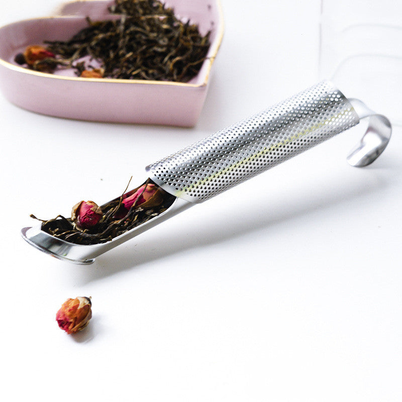 A silver, long-handled tea strainer made of 304 stainless steel. The strainer has a hanging pipe design and a fine mesh basket. It sits in a white mug filled with clear tea.