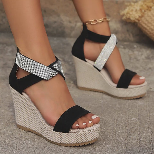 Women's summer wedge sandals with rhinestone embellishments and a fish mouth opening. Platform sole provides comfort and height. Available in black and beige suede.